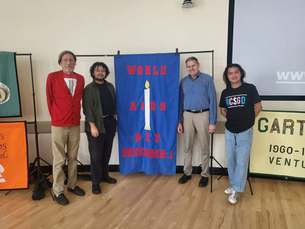 UCSB World AIDS Day 2024 group shot in front of quilt display