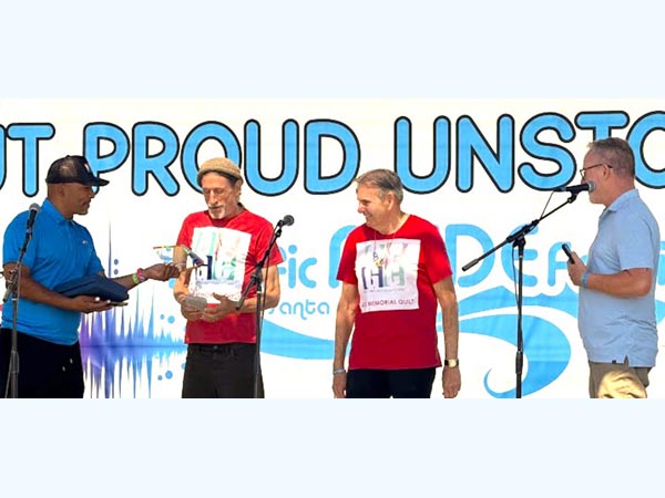 Pacific Pride Association members present the Pride Resilience Award to QPGC